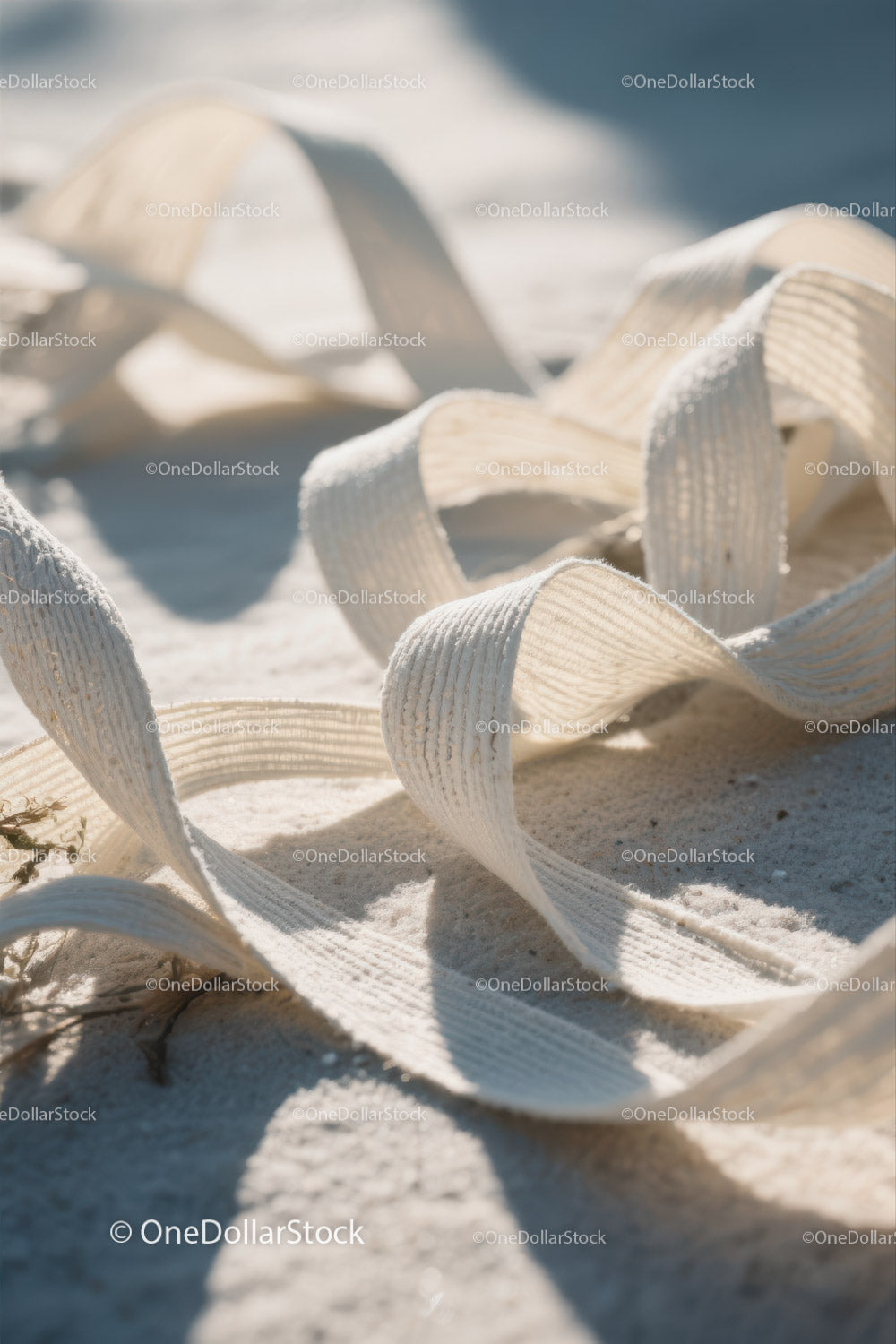 Close-up of White Plastic Ribbon Waste on Sandy Beach