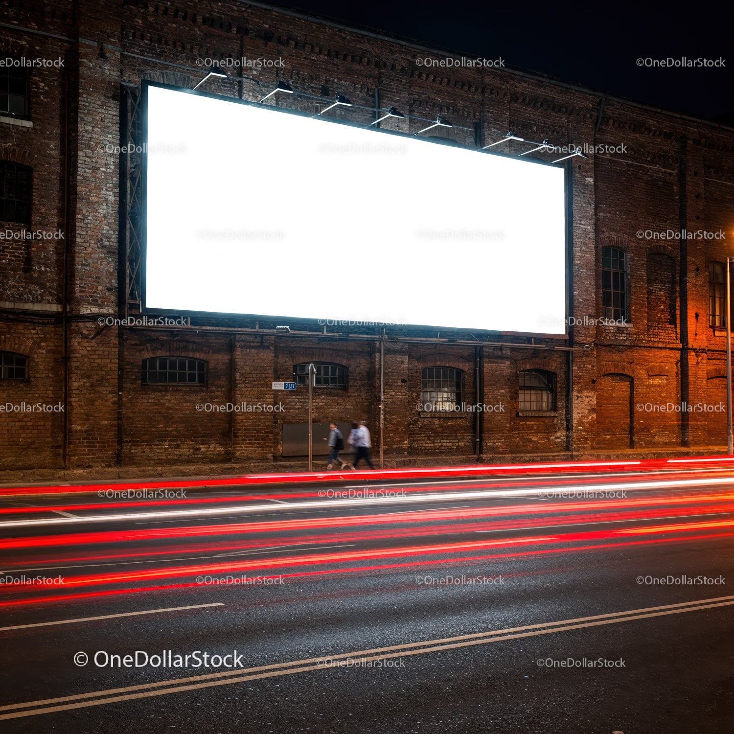 Empty illuminated billboard on brick wall at night street