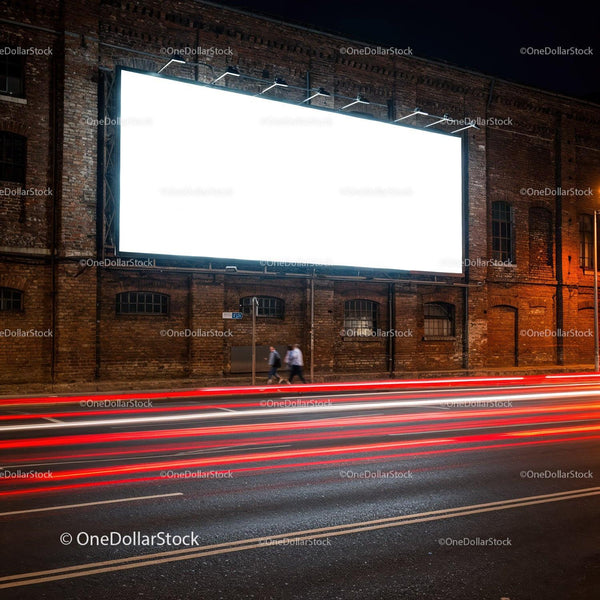 Empty illuminated billboard on brick wall at night street JPG Mockup Image