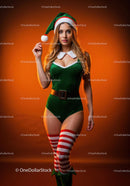 Young woman in festive elf costume on orange background