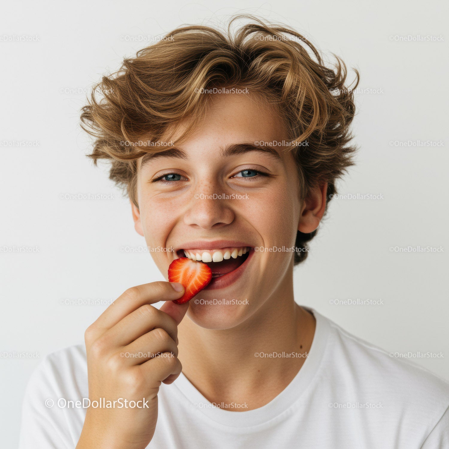 Smiling Boy Enjoying Strawberry Bite with Bright Expression