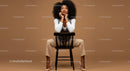 Stylish Confident Woman Sitting on Chair in Modern Studio