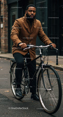 Man Riding Vintage Bicycle in Urban Street Setting