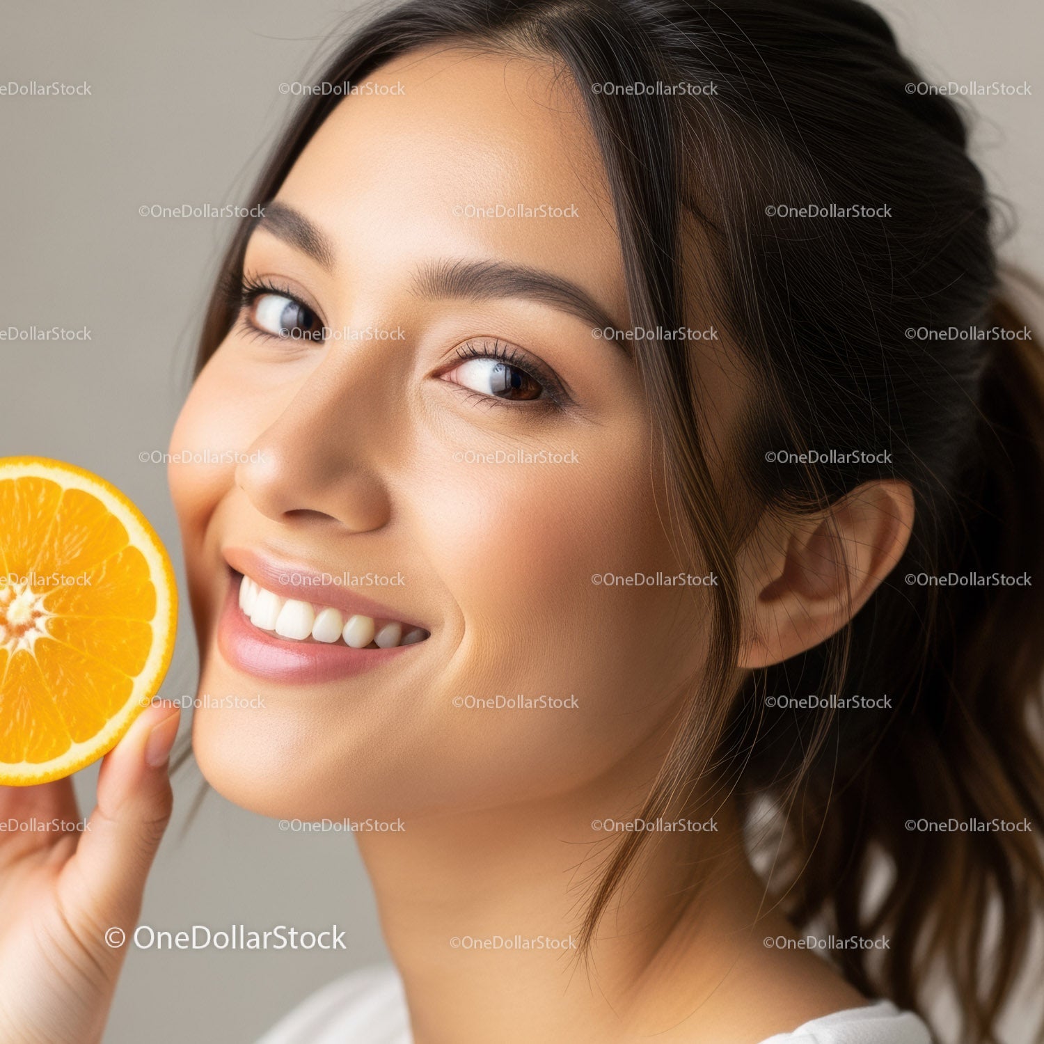 Happy Woman Holding Fresh Orange Slice with Bright Smile