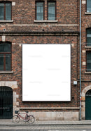 Vintage bicycle parked by red brick wall with blank billboard