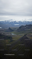 Scenic Mountain Landscape with Snow-Capped Peaks and Mossy Hills