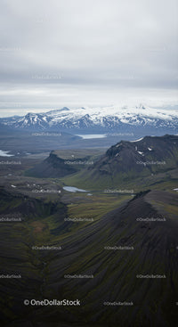 Scenic Mountain Landscape with Snow-Capped Peaks and Mossy Hills