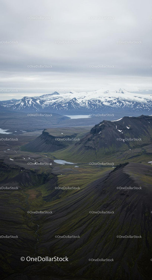 Scenic Mountain Landscape with Snow-Capped Peaks and Mossy Hills