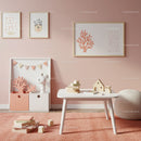 Minimalist Kids Room Decor with Soft Pink Wall Art and Wooden Toys