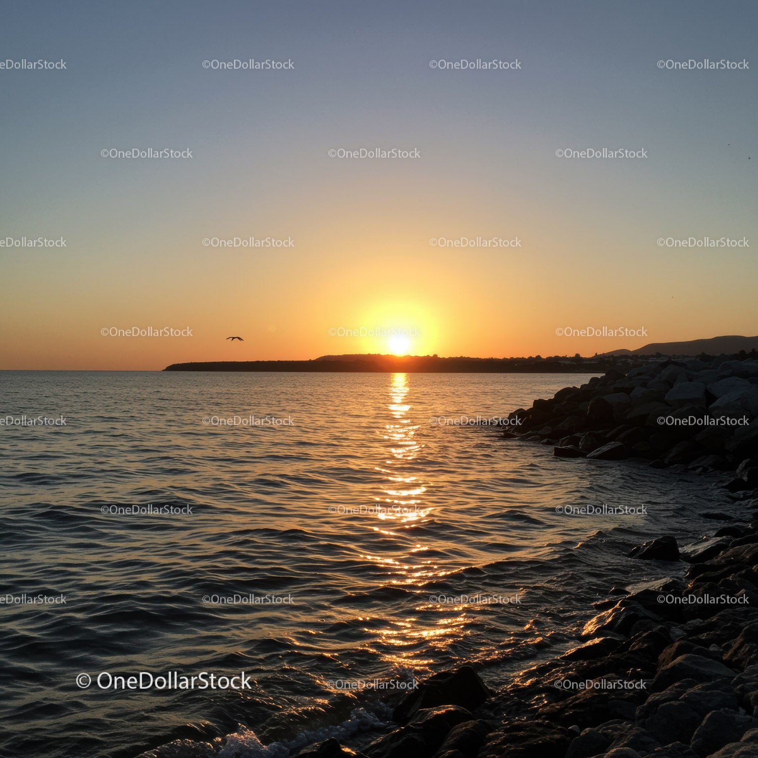 Scenic Sunset Over Rocky Coastline with Calm Ocean Waters