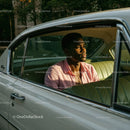Young Man in Pink Shirt Sitting in Vintage Car on a Sunny Day