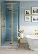 Elegant bathroom with gold accents and blue tiled shower