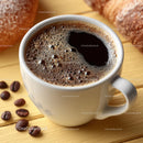 Delicious Coffee in a White Cup with Roasted Beans on Wooden Plate