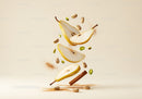 Floating pear slices with pistachios and cinnamon sticks