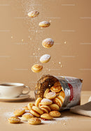 Mini pancakes spilling from bag with powdered sugar dust