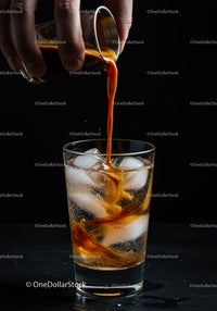 Dark espresso poured over ice in a clear glass