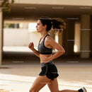 Focused woman running outdoors in urban environment