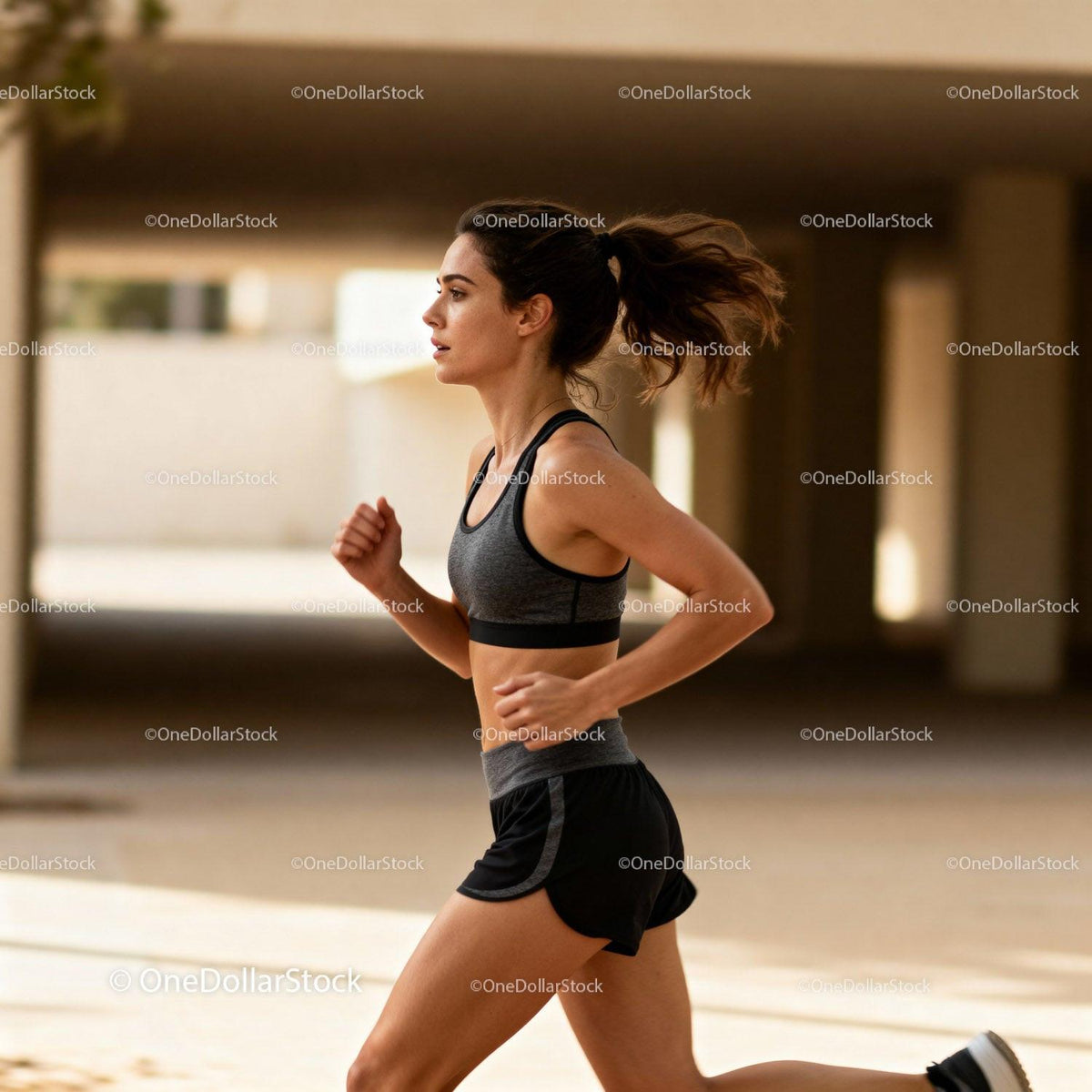 Focused woman running outdoors in urban environment