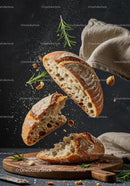 Rustic bread torn apart with fresh rosemary herb on wooden board