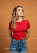 Young woman in red t-shirt looking thoughtful