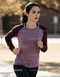 Focused young woman jogging outdoors in autumn light
