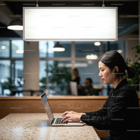 Focused woman working on laptop in modern co working space