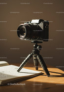 Professional DSLR Camera on Tripod with Notebook in Studio Setting