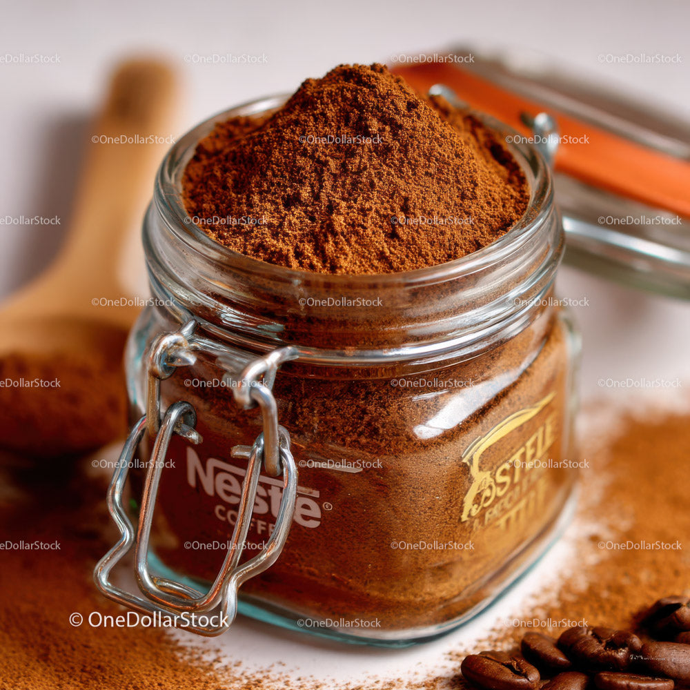 Glass Jar Filled with Fine Ground Coffee and Coffee Beans