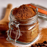 Glass Jar Filled with Fine Ground Coffee and Coffee Beans