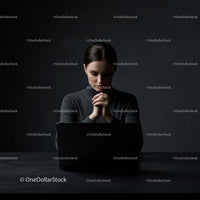 Thoughtful Woman at Laptop in Dark Modern Workspace