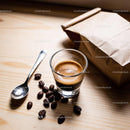 Fresh espresso shot with coffee beans and kraft bag