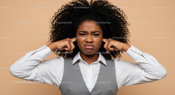 Frustrated Woman Covering Ears in Office Wear Expressing Discontent