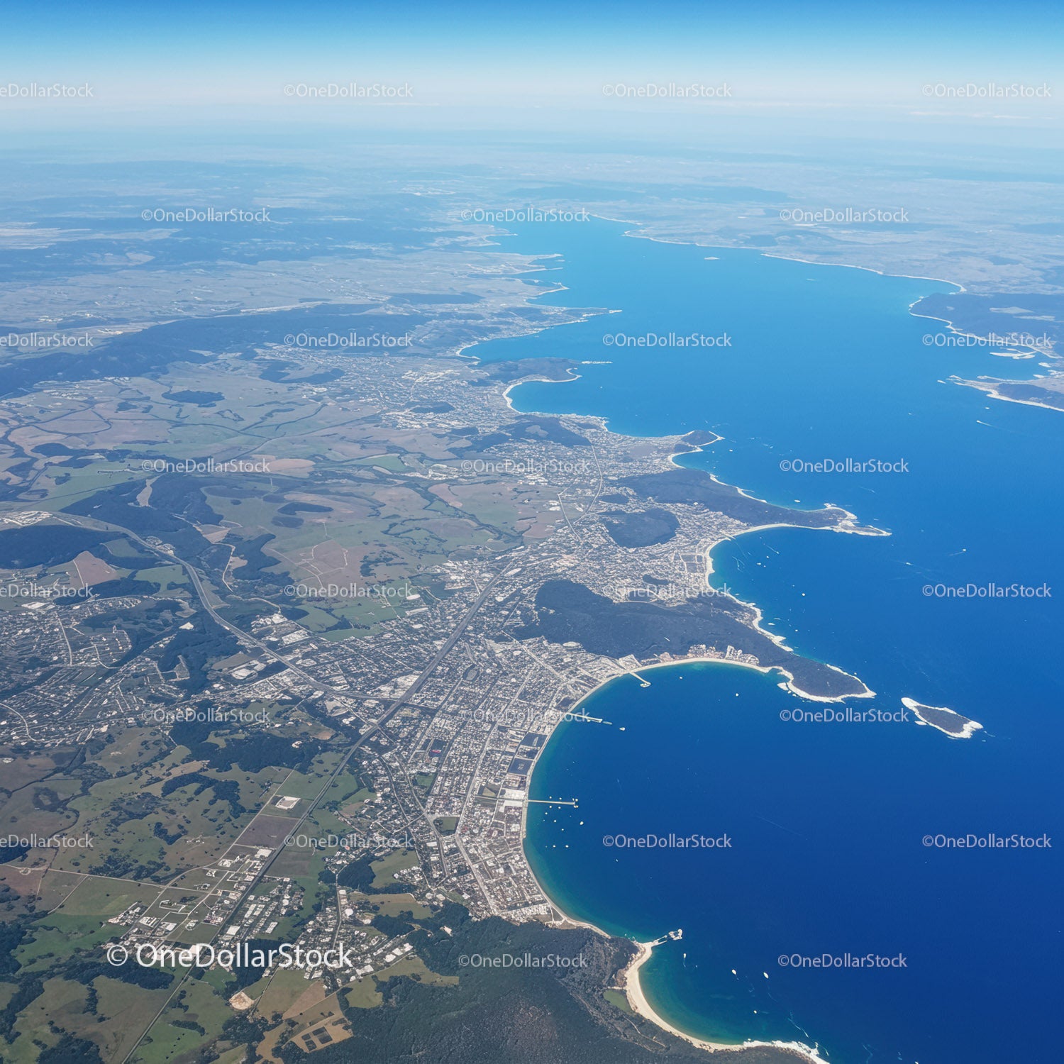 Scenic Coastal City with Blue Lake and Curving Shoreline