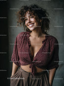 Stylish Woman with Curly Hair in Burgundy Shirt Smiling Portrait