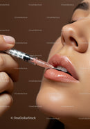 Close-up of Woman Applying Lip Gloss with Shiny Lips