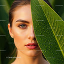 Close-Up of Woman with Green Leaf and Water Droplets in Natural Setting