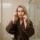 Young Woman Applying Gold Under Eye Patches for Skin Rejuvenation