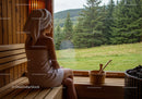 Relaxing Woman Sitting in Sauna with Forest View
