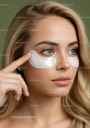 Young Woman with Blonde Hair Applying Eye Patches for Skincare Routine