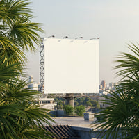 Large blank billboard on rooftop with urban greenery