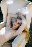 Relaxed woman reclining on cozy beige armchair outdoors
