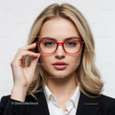 Elegant Woman in Red Glasses with Blonde Hair in Business Attire