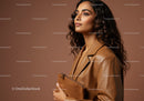 Elegant Woman in Leather Jacket Holding Clutch in Studio