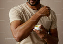 Man Applying Body Lotion on Arm for Skincare and Moisturization
