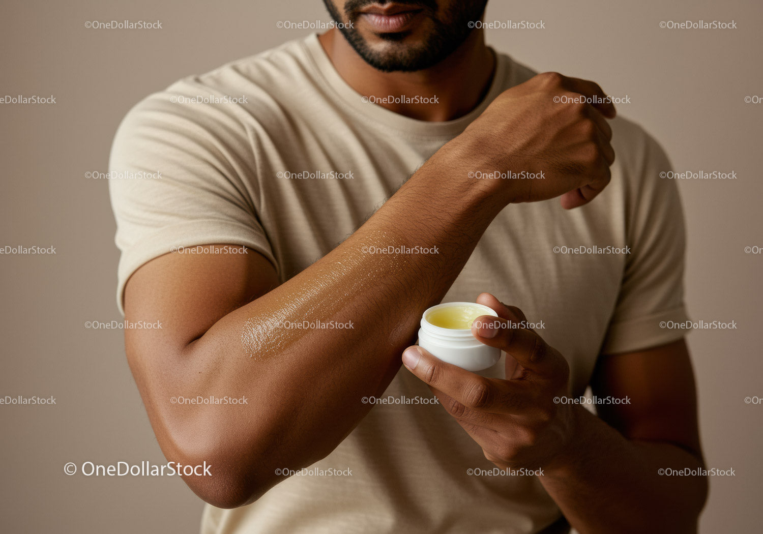 Man Applying Body Lotion on Arm for Skincare and Moisturization