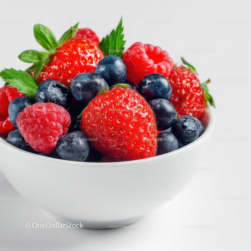 Assorted Fresh Berries in White Bowl with Green Leaves