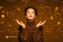 Elegant Woman in Gold Sparkling Dress Amid Festive Confetti