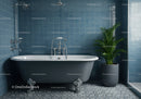Clawfoot bathtub with green plant in blue tiled bathroom