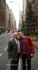 Friends enjoying Christmas spirit on city street