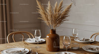 Elegant Dining Table with Pampas Grass Vase and Modern Glassware Setup